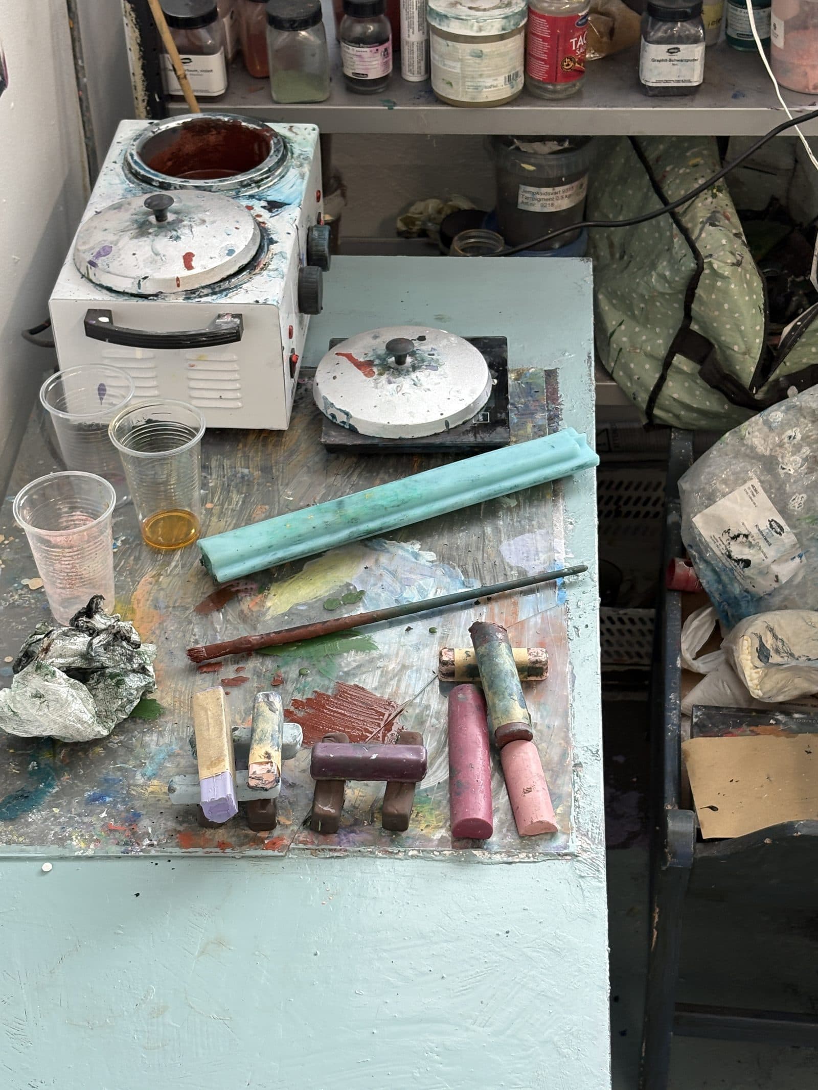 Oil stick and pigment workbench in the studio