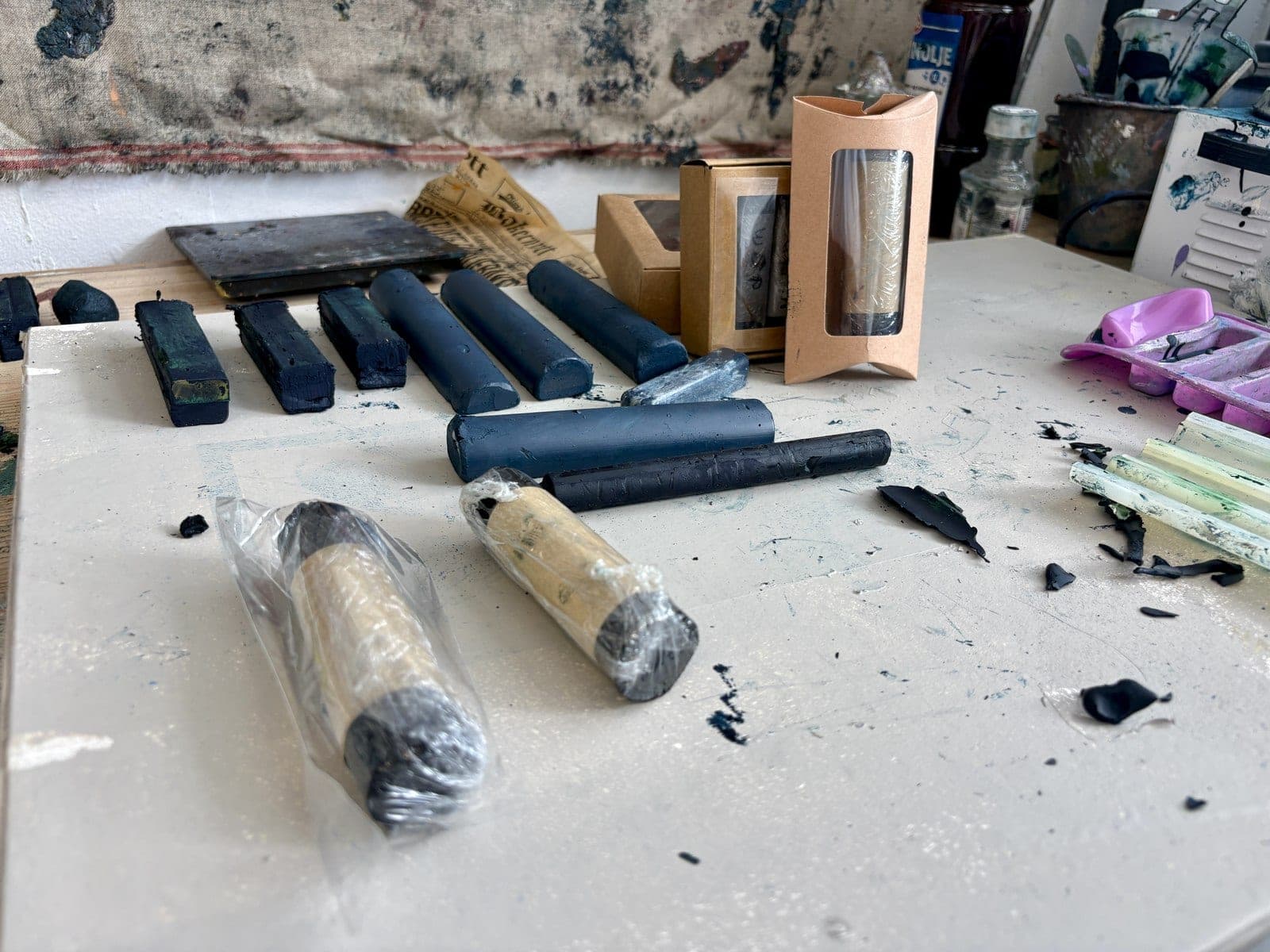 Handmade oil bars made with the Wax & Pigment app, laid out on a studio table
